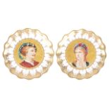 A pair of porcelain portrait plates, of scallop form with central painted portraits