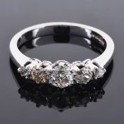 An antique style five stone diamond set ringthe central stone approximately 0.20 ct and with two