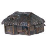 A Meji period Japanese bronze model of a house realistically modelled with thatched roof and figures