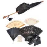 Four assorted fans and a Victorian parasolincluding a wooden fan decorated with winged cherubs and