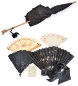 Four assorted fans and a Victorian parasolincluding a wooden fan decorated with winged cherubs and