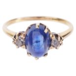 A blue cabochon sapphire and diamond set ringthe oval sapphire of good colour and with small diamond