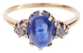 A blue cabochon sapphire and diamond set ringthe oval sapphire of good colour and with small diamond