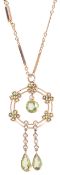 A charming Edwardian peridot and pearl drop pendant on chainthe circular pendant set with five