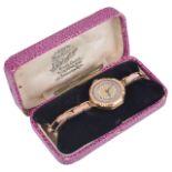 A 9ct Bravingtons gold ladies wristwatch, the engine turned gilt dial with arabic hours, spade