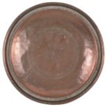 A large Islamic circular copper tray with bead and fluted border
