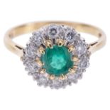 An emerald and diamond set daisy cluster ringthe central circular emerald of good colour and set