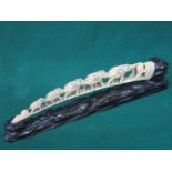 HEAVILY CARVED IVORY ELEPHANT BRIDGE WITH MOTHER OF PEARL DECORATION ON CARVED TREEN STAND