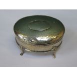 SMALL SILVER HAMMERED OVAL STORAGE BOX WITH COVER ON RAISED SUPPORTS