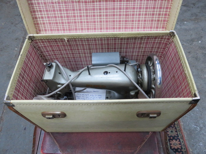 CASED SEWING MACHINE