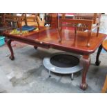 MAHOGANY EXTENDING DINING TABLE WITH TWO LEAVES ON CARVED BALL AND CLAW SUPPORTS