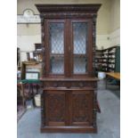 CONTINENTAL STYLE HEAVILY CARVED TWO DOOR LEADED GLASS BOOKCASE