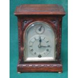 CARVED FRONTED OAK CASED SMALL BRACKET CLOCK WITH SILVER COLOURED DIAL,