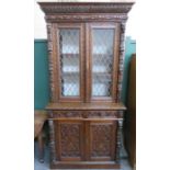 CONTINENTAL STYLE HEAVILY CARVED TWO DOOR LEADED GLASS BOOKCASE