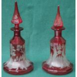 PAIR OF ETCHED RUBY COLOURED VENETIAN STYLE GLASS DECANTERS WITH STOPPERS (AT FAULT),