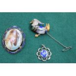 THREE ENAMELLED COSTUME BROOCHES