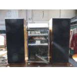 STEREO STACKING SYSTEM IN GLASS CABINET (AT FAULT) WITH FREE STANDING SPEAKERS