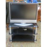 PANASONIC VIERA FLATSCREEN TELEVISION ON BLACK GLASS TELEVISION STAND