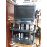 FLATSCREEN TELEVISION AND BLACK GLASS STAND