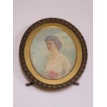 OVAL MINIATURE PORTRAIT DEPICTING AND EDWARDIAN LADY WITHIN GILT METAL FREE STANDING FRAME