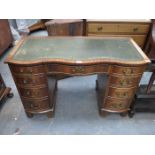 SERPENTINE FRONTED KNEEHOLE WRITING DESK WITH GREEN LEATHER INSERT