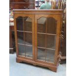 WALNUT VENEERED TWO DOOR DISPLAY CABINET