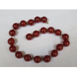 STRAND OF CHERRY AMBER BEADS