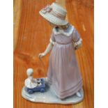 LLADRO GLAZED CERAMIC FIGURE OF A LADY WITH DOLL,