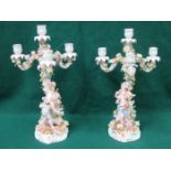 PAIR OF MEISSEN FLORAL RELIEF DECORATED THREE SCONCE CERAMIC CANDELABRAS DEPICTING TWO CHERUBS,