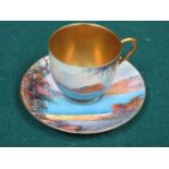 ROYAL WORCESTER HANDPAINTED AND GILDED CERAMIC CUP AND SAUCER DECORATED WITH A CONTINENTAL LAKE