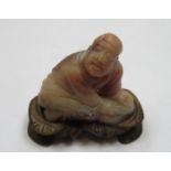 CARVED ORIENTAL KNEELING GENT ON WOODEN STAND