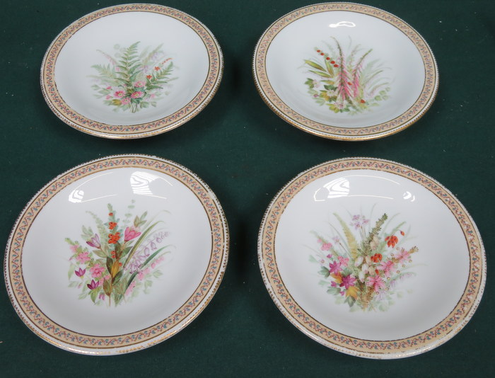 SET OF FOUR HANDPAINTED AND GILDED ROYAL WORCESTER CERAMIC CAKE PLATES