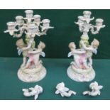 PAIR OF CONTINENTAL STYLE CHERUB FORM CANDELABRA (AT FAULT)