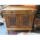 CARVED FRONTED OAK TWO DOOR CUPBOARD WITH SINGLE DRAWER TO TOP