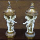 PAIR OF DECORATIVE FIGURE FORM CANDLE STANDS WITH COVERS,