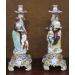 PAIR OF CONTINENTAL STYLE HANDPAINTED AND GILDED RELIEF DECORATED FIGURE FORM CANDLESTICKS,