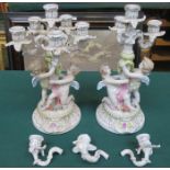PAIR OF CONTINENTAL STYLE CHERUB FORM CANDELABRA (AT FAULT)