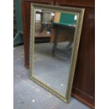 LARGE GILT FRAMED AND BEVELLED WALL MIRROR