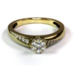 A 9ct yellow gold diamond set daisy cluster ring with diamond set shoulders (L).