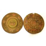 A pair of interesting early 20th century Indian hammered brass trays decorated with scenes of a