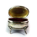 A small hallmarked silver velvet lined box, raised on four scroll feet, Syner & Beddos, Birmingham