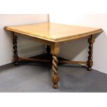 A golden oak barley twist leg dining table, 140 x 108cm.