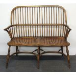 A rare elm double Windsor chair, raised on turned supports with a double crinoline stretcher.