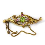 An Edwardian 15ct yellow gold brooch set with a brilliant cut peridot, pink sapphires and seed