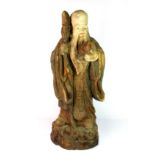 A large Chinese painted and ghessoed carved wooden figure of Shou Lao, H. 54cm.