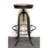 An interesting revolving cast iron stool, H. 65cm.
