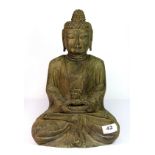 A Chinese carved stone figure of a seated Buddha, H. 36cm.