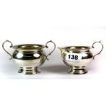 A hallmarked silver milk jug and two handled sugar basin, bearing the crest for the Coventry family,