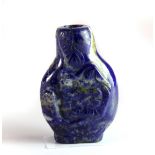 A Chinese carved lapis lazuli snuff bottle decorated with a fish on one side and a snake on the