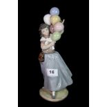 A Lladro figure of a girl with balloons, H. 27cm.